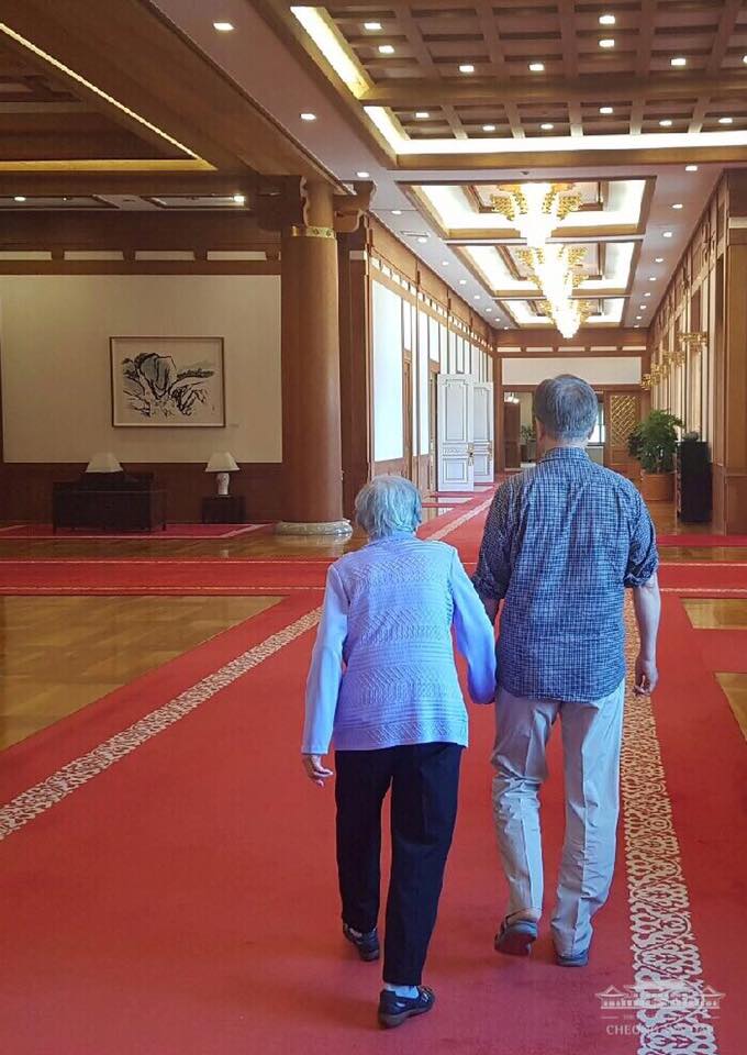 문재인 대통령이 지난 여름 어머니의 손을 잡고 청와대를 둘러보고 있다. [출처=청와대]