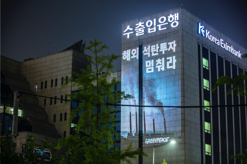 국제환경단체 그린피스 서울사무소가 6월 30일 저녁 여의도 수출입은행 건물에 레이저빔을 투사해 '해외 석탄 투자 멈춰라' 등의 메시지를 새겼다.(사진 그린피스 제공)