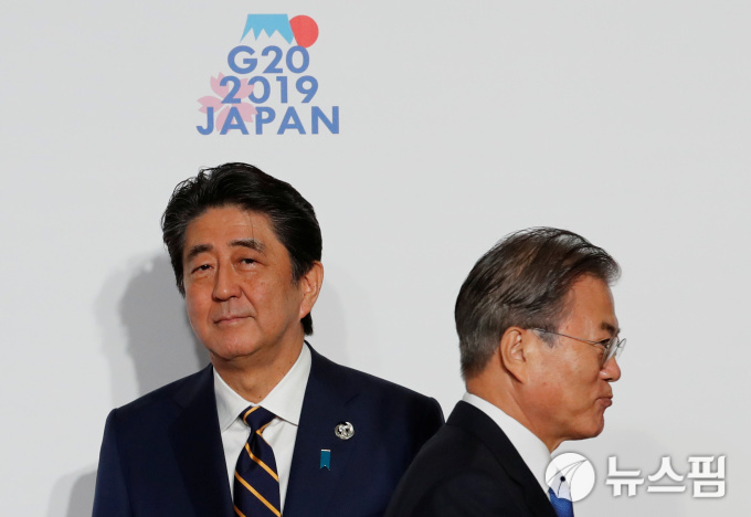문재인 대통령이 G20 정상 환영 및 기념촬영 식순 중에 아베 신조 일본 총리 앞을 지나가고 있다. (사진 로이터 뉴스핌 제공)
